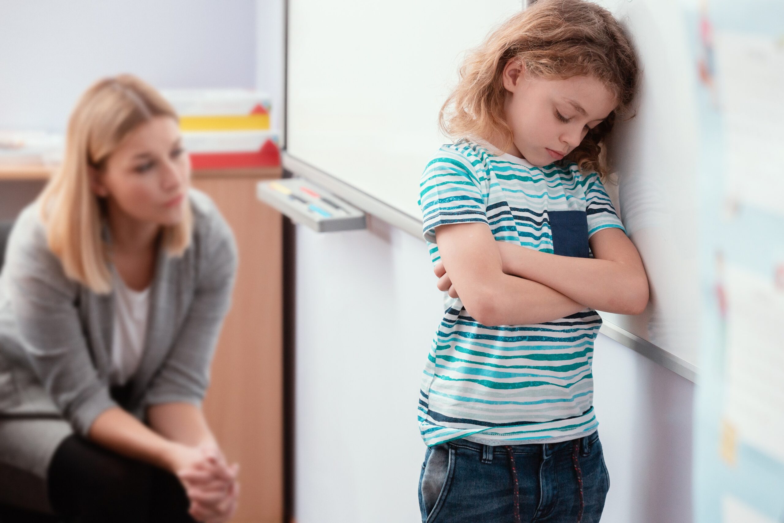 offended-child-stands-with-his-arms-folded-in-the